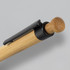 A bamboo pen with a black clip and a rounded wooden tip, featuring a natural finish.