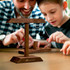 A wooden Keepsake Ring Toss Game featuring a balanced frame and rings, with a father and son playing together.