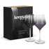 A set of two gradient purple wine glasses with stems, packaged in a sleek black box featuring a logo.