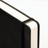 A5 daily diary in black, featuring a sleek cover and an elastic band closure.