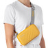 A yellow Rollink Mini Bag Tour worn across the body, featuring a quilted design and a grey strap.
