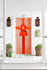Bright orange oversized door bow mounted on a front door for event displays and promotional styling