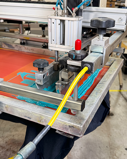 Screen printing a garment on the production floor