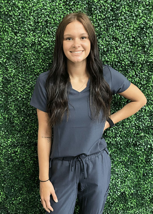 Medical professional wearing a comfortable dark grey scrub shirt