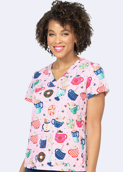 Healthcare professional wearing a fun mug-themed scrub top