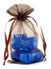 Chocolate sheer organza bag with satin ribbon drawstring closure. Transparent chocolate-colored organza material shown holding small items inside a lightweight drawstring presentation bag.

