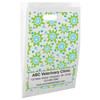 White die-cut handle paper bag featuring a repeating pattern of green splash shapes with blue paw print centers and scattered blue paw prints.

