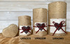 Pet Peaceful Return Kraft Heart Small pet memorial urn with natural fiber finish, white memorial panel, dark brown heart accent, and red ribbon detail.