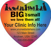 Heart-shaped veterinary die-cut magnet featuring a rainbow gradient background with multiple animal silhouettes and personalized clinic information.

