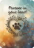 Front features “Forever in your heart” with a heart-shaped paw print illustration and floral accents; back displays a remembrance message with paw prints on a soft bokeh background.

