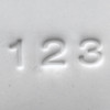 Close-up of number impressions 1, 2, and 3 pressed into clay using the Pawprint Impression Kit Number Stamp Set with bold block style characters.

