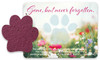 Purple paw-shaped seed paper displayed beside a floral memorial card with a translucent paw print and the phrase “Gone, but never forgotten.”

