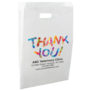 White die-cut handle paper bag featuring the message “THANK YOU!” in large multicolored geometric lettering above a clinic information area.

