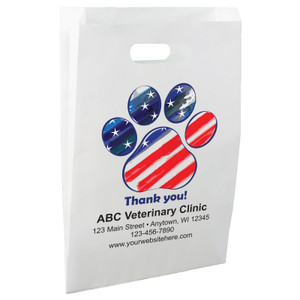 White die-cut handle paper bag featuring a red, white, and blue patriotic paw print with stars and stripes above the message "Thank you!"

