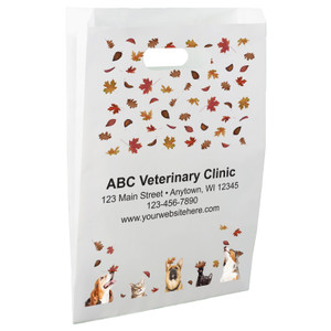 White die-cut handle paper bag featuring falling autumn leaves and dogs and cats looking upward from the bottom border.

