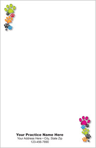 Half-size veterinary notepad with colorful paw print clusters in the upper left and lower right corners, gray background, and practice information area at the bottom.

