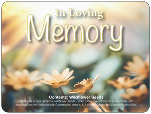 Wildflower Memorial Loose Seed Pack featuring soft yellow flowers, a blurred floral background, and the words “In Loving Memory” across the top.

