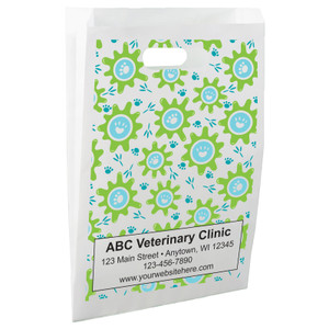 White die-cut handle paper bag featuring a repeating pattern of green splash shapes with blue circles containing white paw print icons.

