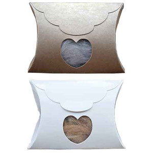 Veterinary memorial pillow envelopes shown in two color options, Kraft Brown and Glossy White, each featuring a cellophane-covered heart-shaped viewing window displaying a pet fur keepsake. Pillow-style envelopes include a resealable side opening and ship flat for storage and memorial presentation.

