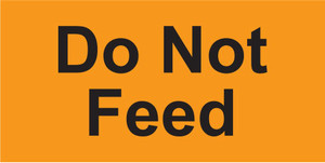 Bright orange rectangular sticker with black text reading Do Not Feed

