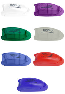 Personalized pill cutter shown in purple, green, blue, frosted white, red, and blue color options with custom clinic name, phone number, and website printed on the top imprint area.