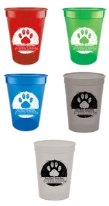 Personalized pet food measuring cup featuring a large distressed paw print graphic with custom clinic name, address, phone number, fax number, and website information printed across the lower portion of the design.