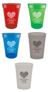 Personalized pet food measuring cup featuring a heart shape created from multiple paw prints above the phrase "We love pets!" with custom clinic name, address, phone number, fax number, and website information.