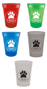 Personalized pet food measuring cup featuring a large paw print inside a circular border with custom clinic information printed inside a dog bone graphic at the bottom of the design.
