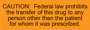 Orange caution label with prescription transfer restriction text in black lettering

