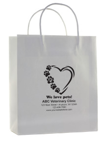 White handled paper bag featuring heart outline and paw print trail with customizable clinic information.