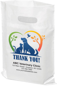 Silhouette of dog and cat in a colorful branches that make a heart shape on a white plastic tote bag.