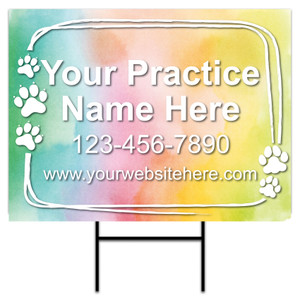 18" x 24" personalized yard sign with a pastel watercolor background, white hand-drawn border, five white paw print graphics, large centered practice name text, phone number, website area, and included H-stake.