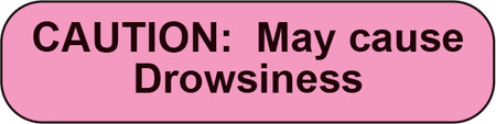 Pink rounded sticker with black text CAUTION May cause Drowsiness