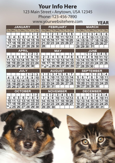 Close-up puppy and tabby kitten portraits beneath a year calendar with brown month headers and personalized business information area.