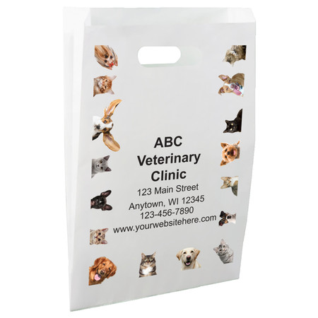 White die-cut handle paper bag featuring a border of dog and cat photographs surrounding a central clinic information area.

