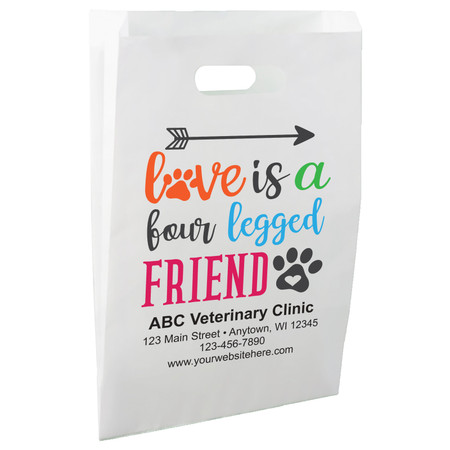 White die-cut handle paper bag featuring the phrase "love is a four legged FRIEND" with colorful lettering, paw prints, and an arrow graphic.

