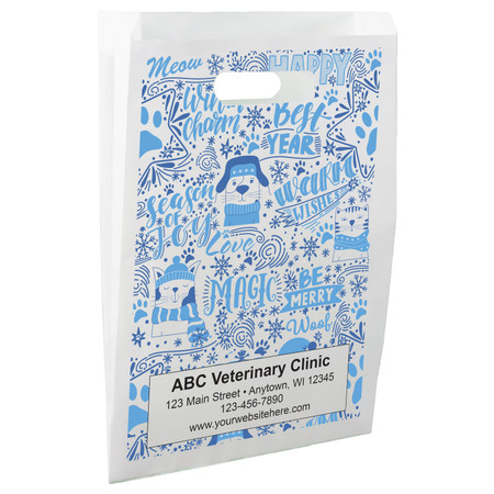 White die-cut handle paper bag featuring blue winter pet illustrations, paw prints, snowflakes, and seasonal phrases in a full-coverage pattern.

