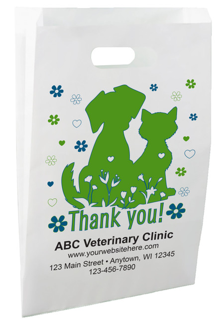 White die-cut handle paper bag featuring green dog and cat silhouettes surrounded by blue and green flowers, hearts, and the message "Thank you!"