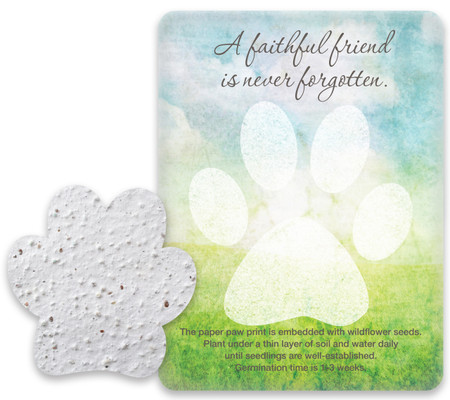 White paw-shaped seed paper displayed beside a blue and green memorial card with a large paw print and the phrase “A faithful friend is never forgotten.”

