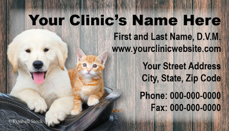 Veterinary business card featuring a puppy and orange tabby kitten in front of a rustic wood plank background with clinic contact information.

