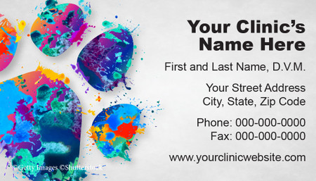 
Veterinary business card featuring a large multicolored watercolor paw print with paint splatter effects and clinic contact information on a light gray background.

