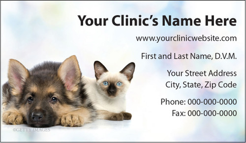 Veterinary business card featuring a German Shepherd puppy and a Siamese cat on a soft pastel background with clinic contact information.

