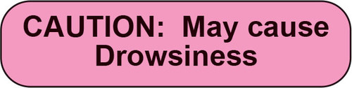 Pink rounded sticker with black text CAUTION May cause Drowsiness