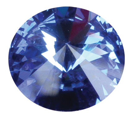 Round deep blue September crystal gemstone with a faceted cut design and reflective surface, shown individually and displayed as an accent option on a memorial paw print keepsake.

