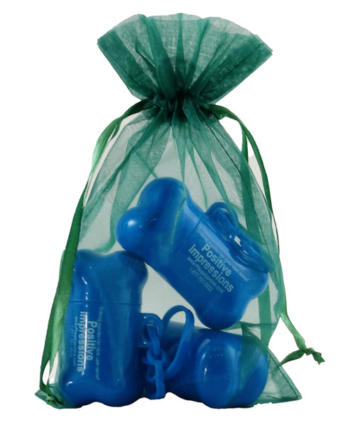 Emerald sheer organza bag with satin ribbon drawstring closure. Transparent emerald-colored organza material shown holding small items inside a lightweight drawstring presentation bag.

