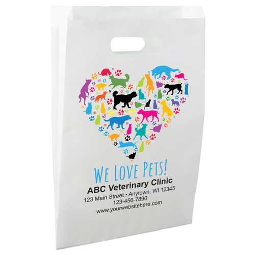 White die-cut handle paper bag featuring a heart-shaped arrangement of colorful dog and cat silhouettes with multicolored paw prints and the message "WE LOVE PETS!"


