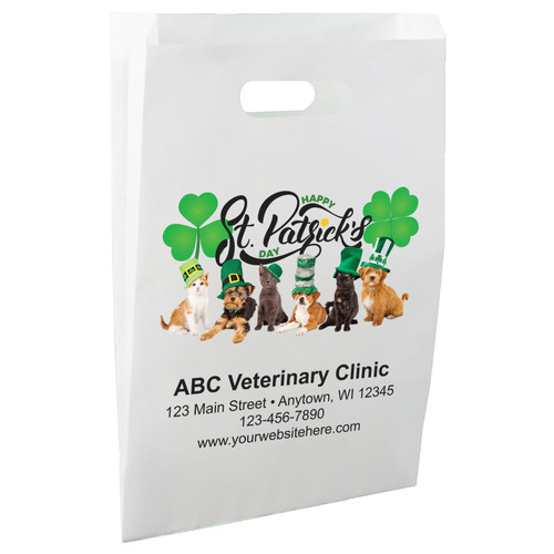 White die-cut handle paper bag featuring dogs and cats wearing green hats beneath a Happy St Patrick's Day message with large green shamrocks.

