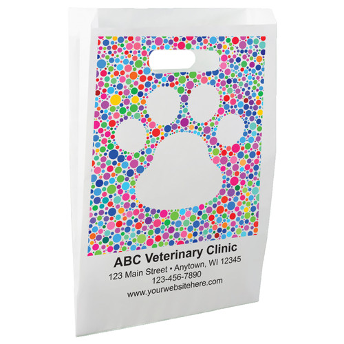 White die-cut handle paper bag featuring a large paw print created from colorful polka dots in varying sizes.