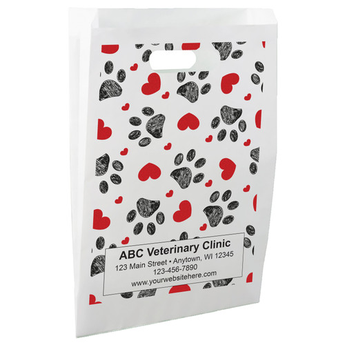 White die-cut handle paper bag featuring a repeating pattern of red hearts and black sketched paw prints.

