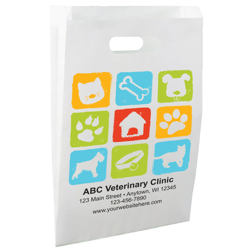 White die-cut handle paper bag featuring a colorful grid of pet care icons including a cat, dog, bone, paw print, pet house, collar, and animal silhouettes.

